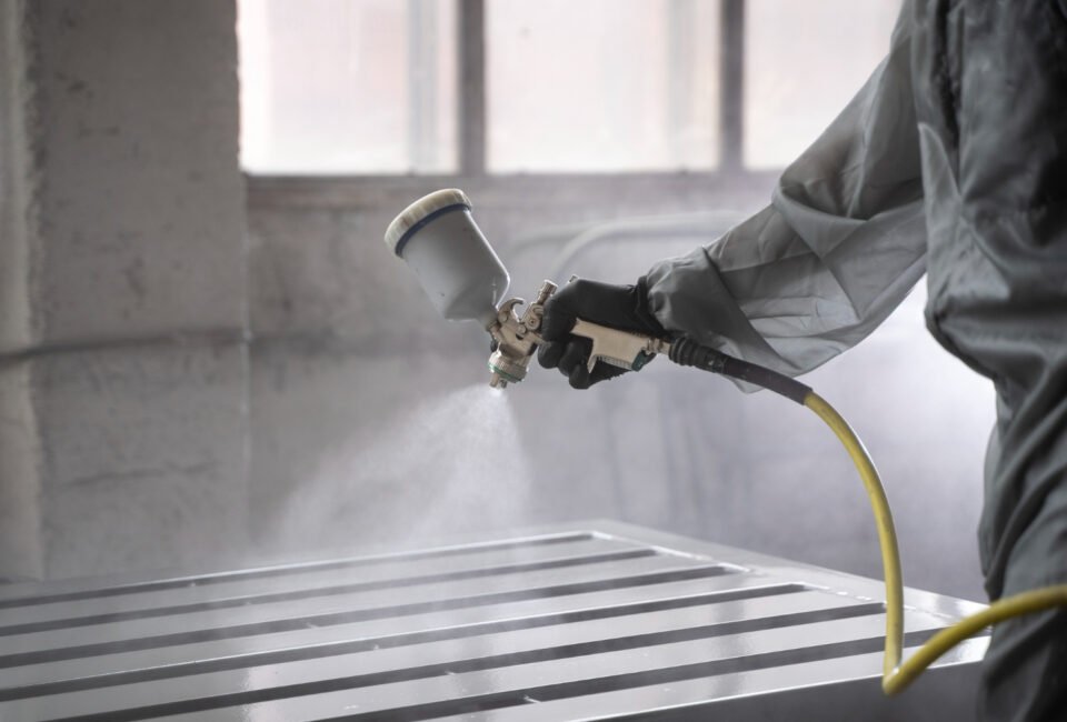 side-view-worker-spraying-powder-paint